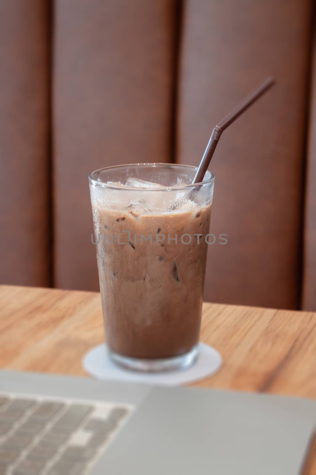 Iced coffee in coffee shop on wooden table, stock photo