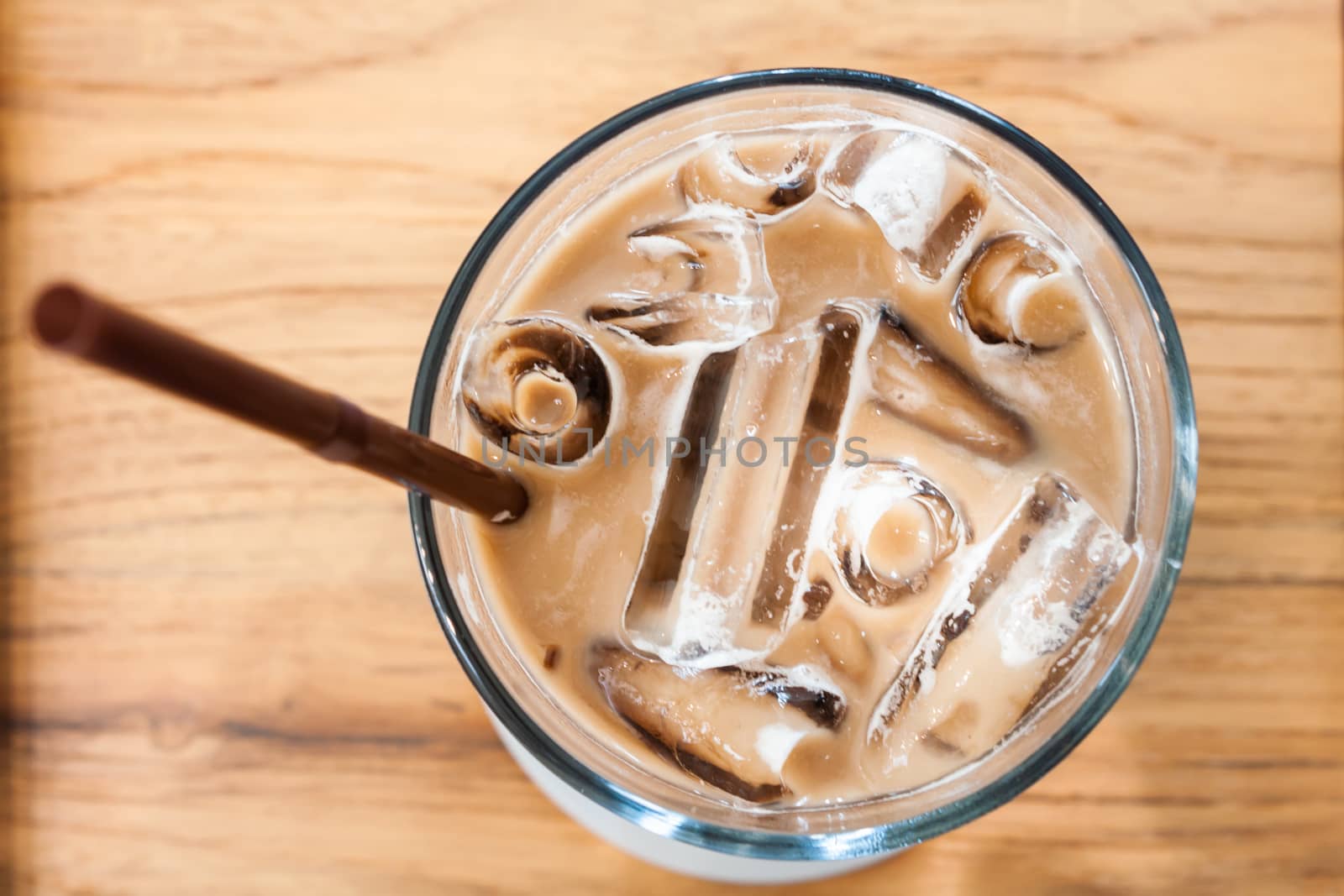 Iced coffee in coffee shop on wooden table, stock photo