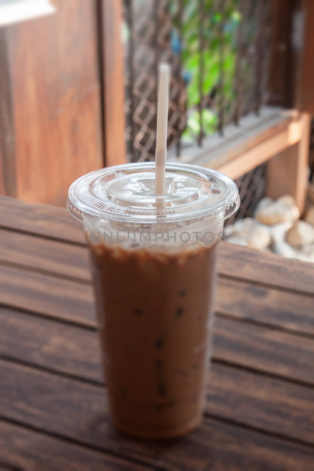 Iced coffee in coffee shop on wooden table by punsayaporn