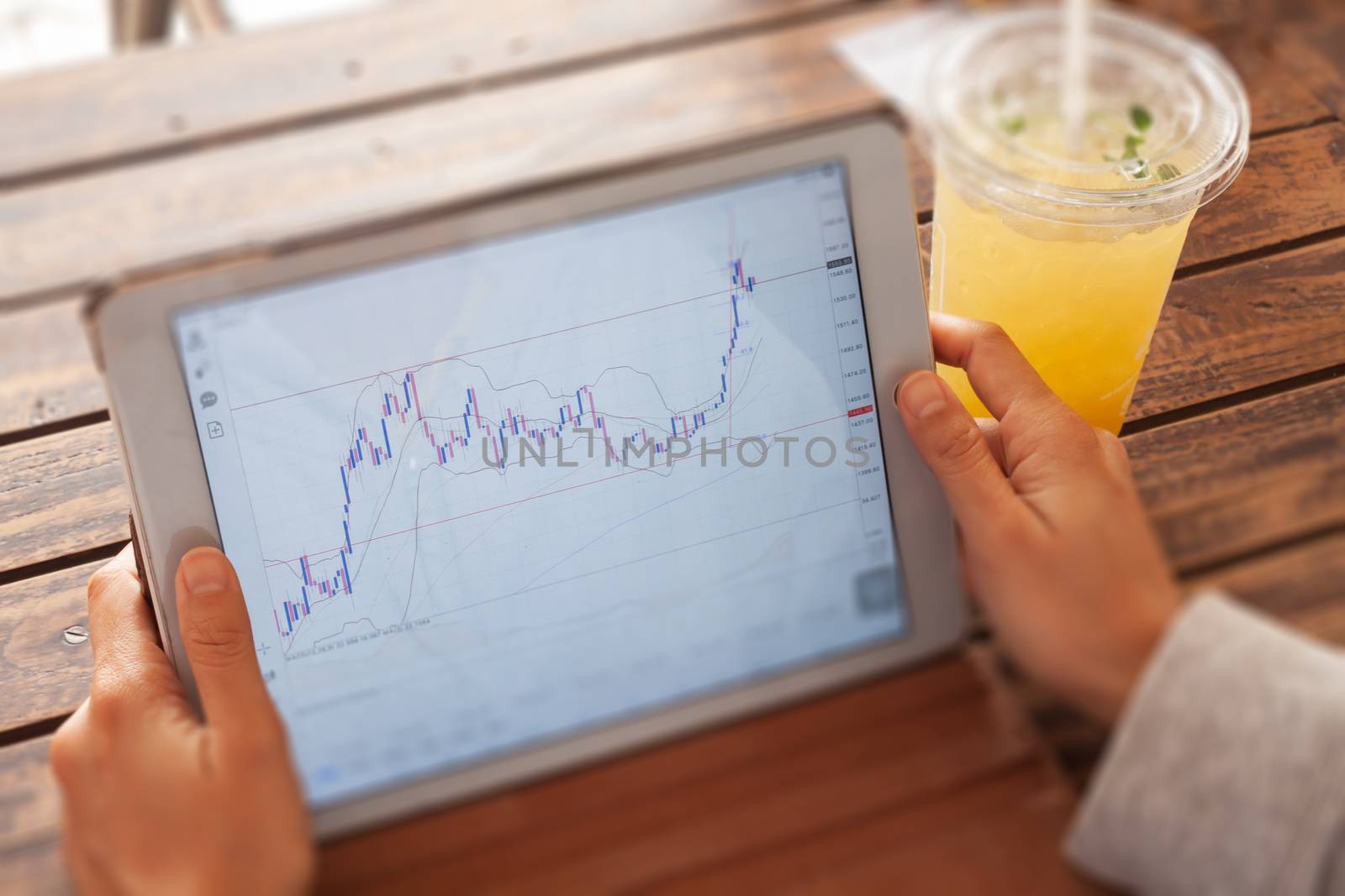 Woman hand trading online on tablet, stock photo