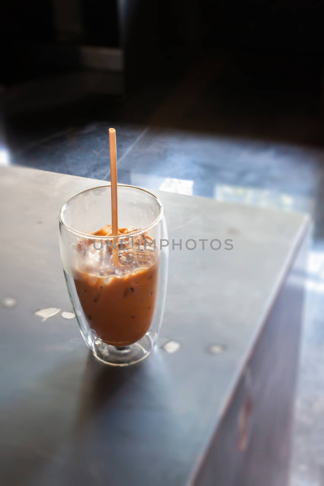 Iced coffee in coffee shop on wooden table, stock photo