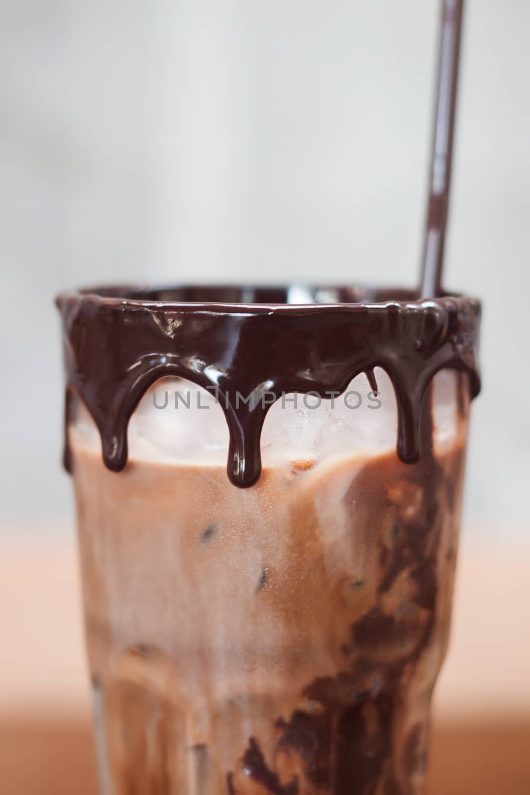 Ice coffee on wooden table by punsayaporn