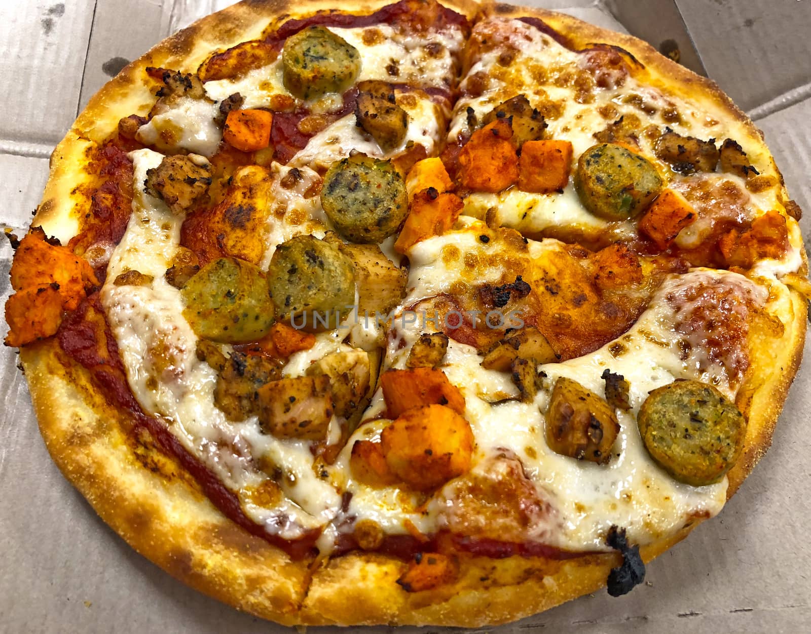 Beautiful view of sliced chicken pizza served in the restaurant for eating