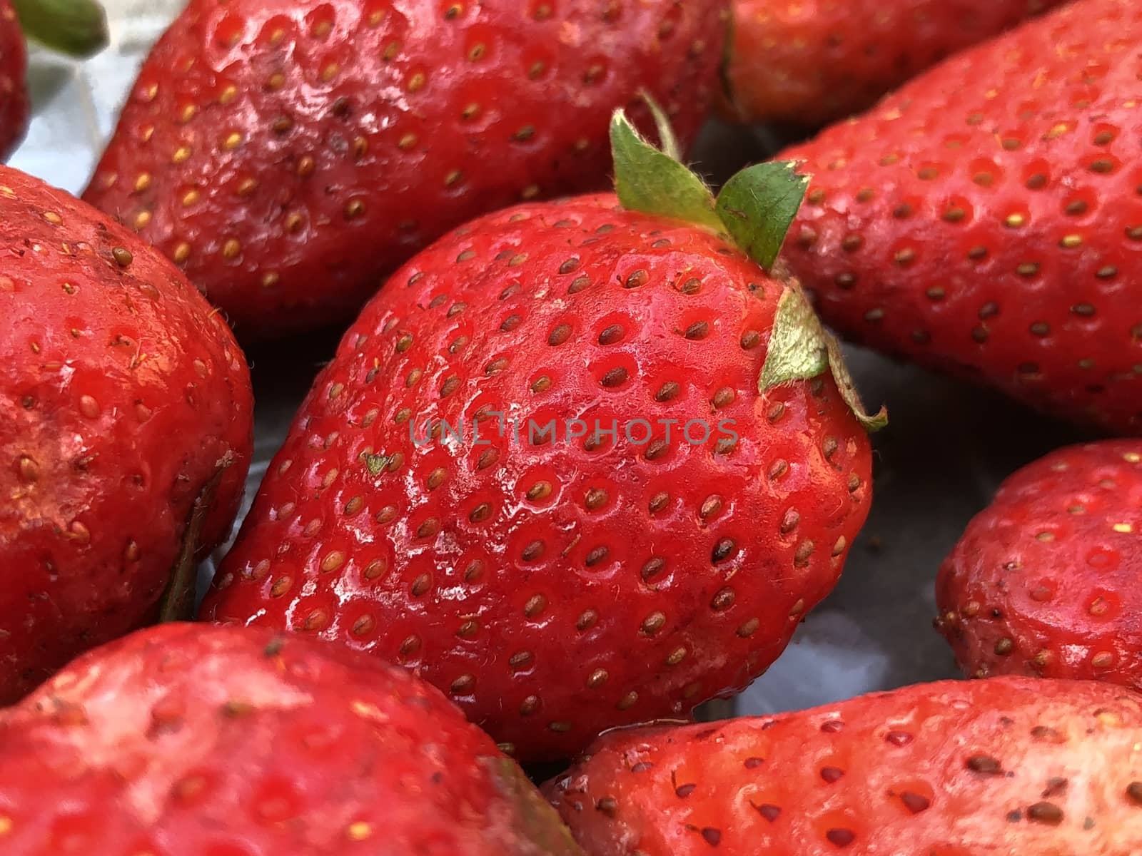 Beautiful view of red color strawberry fruit kept for sale in the market