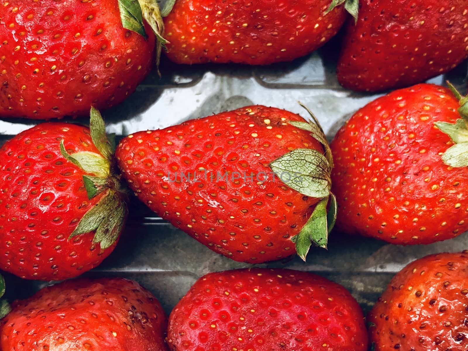 Beautiful view of red color strawberry fruit kept for sale in the market