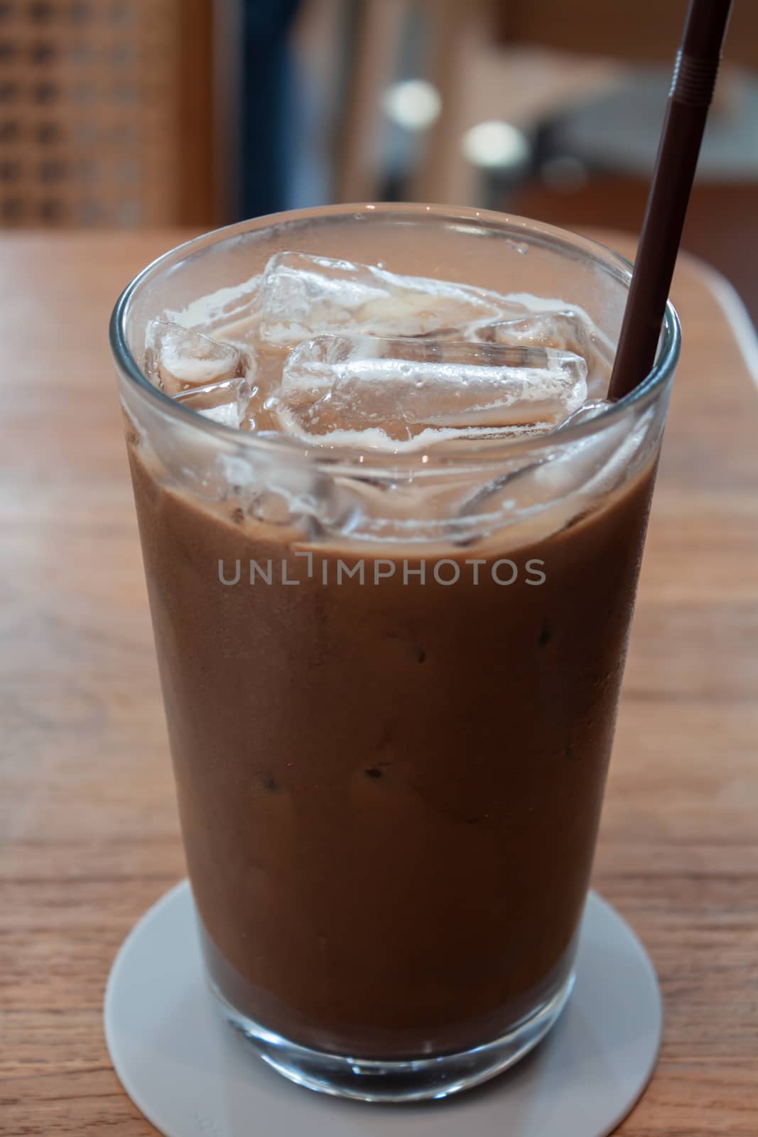 Iced coffee in coffee shop on wooden table, stock photo