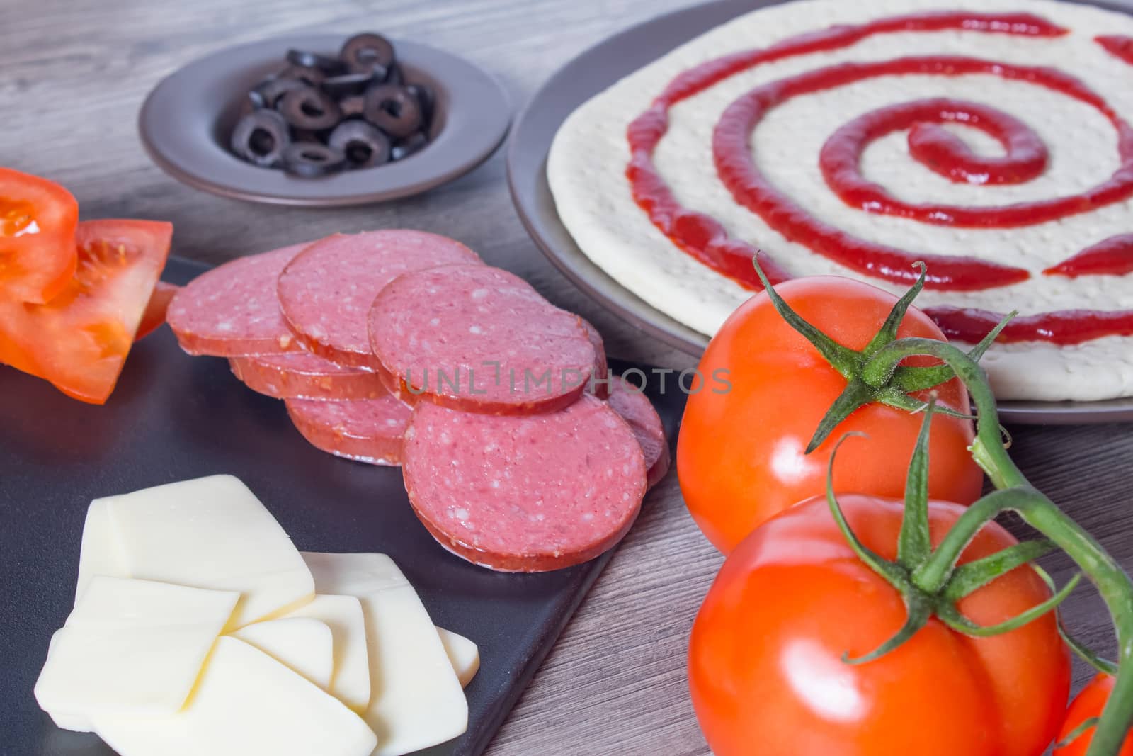 Pizza base and ingredients for its preparation. Tomatoes, sausag by YevgeniySam