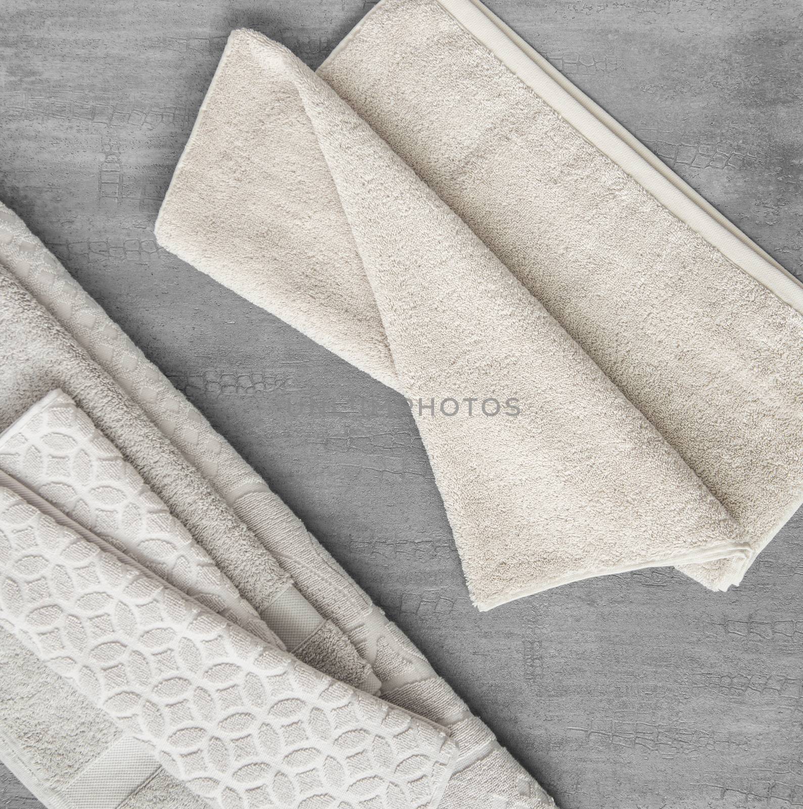 soft towel in a grey decorative stucco background. top view, isolated