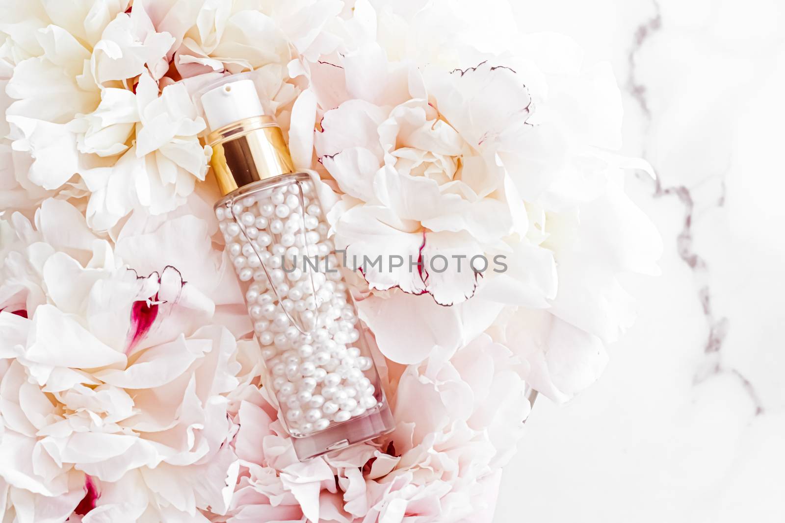 Luxurious cosmetic bottle as antiaging skincare product on background of flowers, blank label packaging for body care branding design