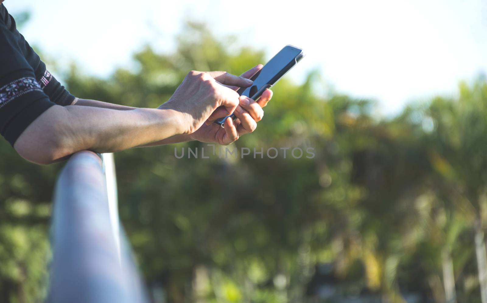 Hand of woman using smartphone, personal chat, and social media.