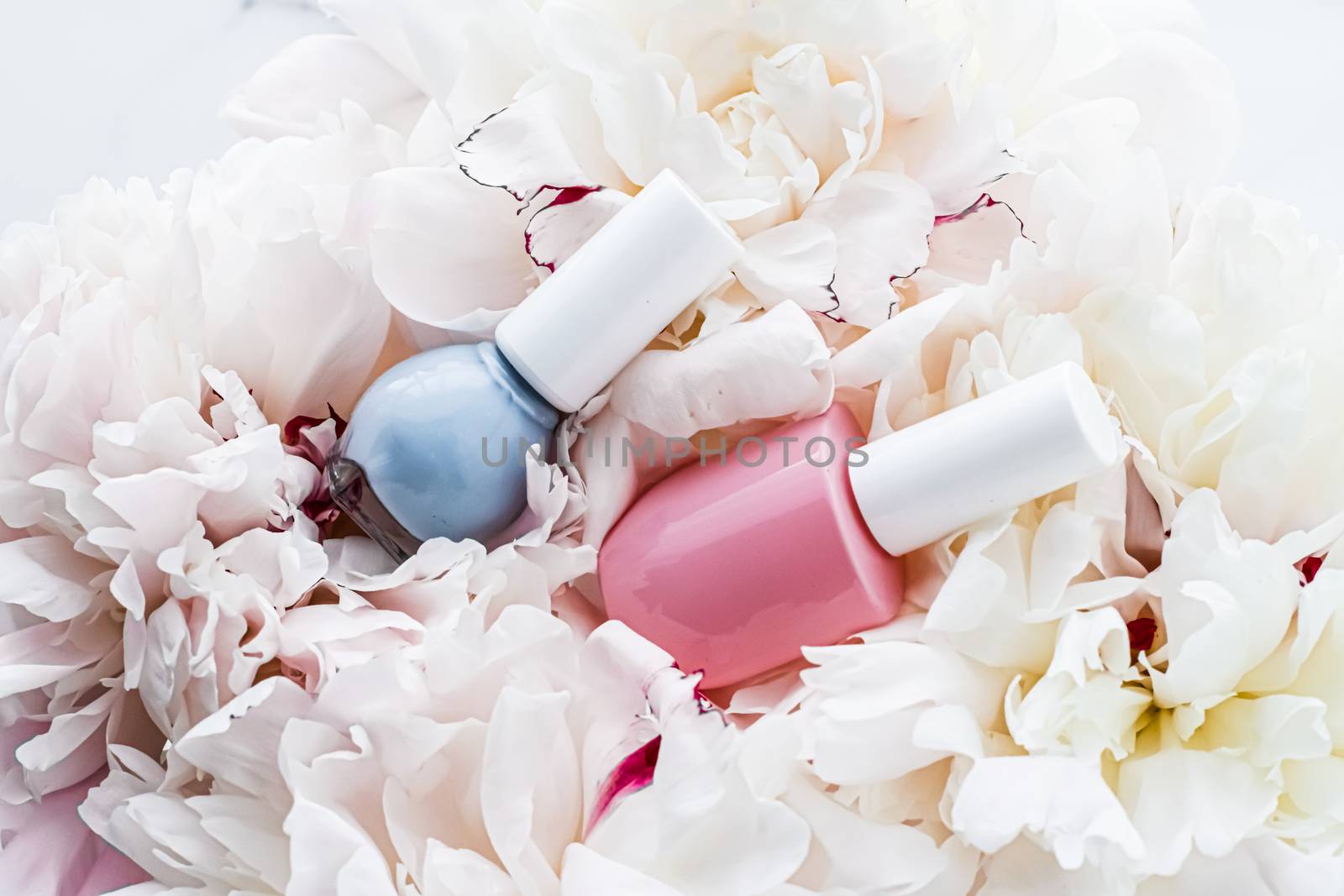 Nail polish bottles on floral background, french manicure and cosmetic branding by Anneleven