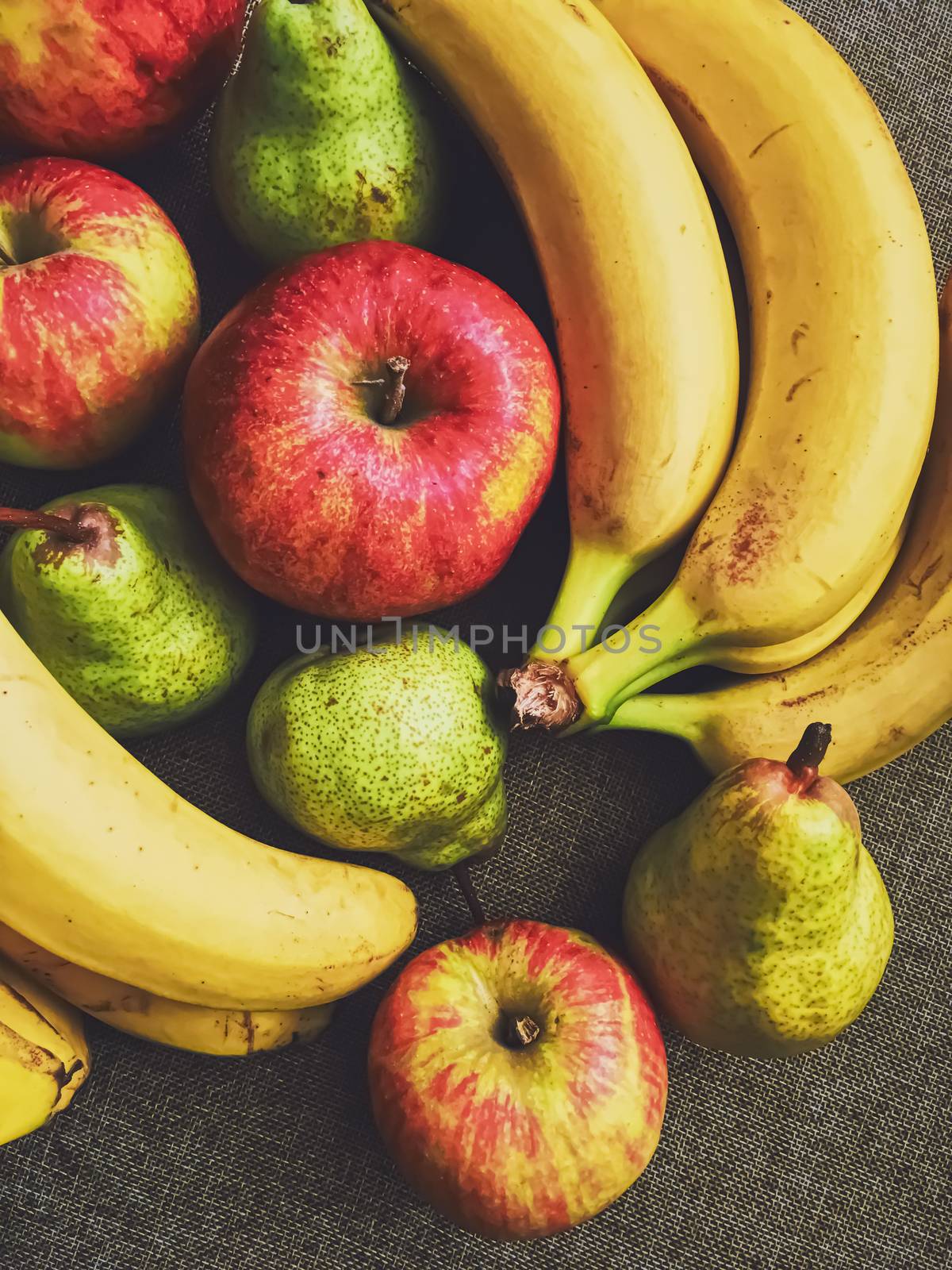 Organic apples, pears and bananas on rustic linen background, fruits farming and agriculture