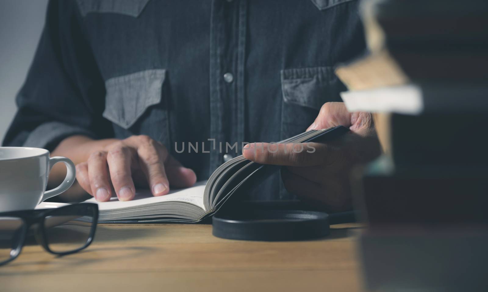 Man reading a book on the table. Education and people concept.