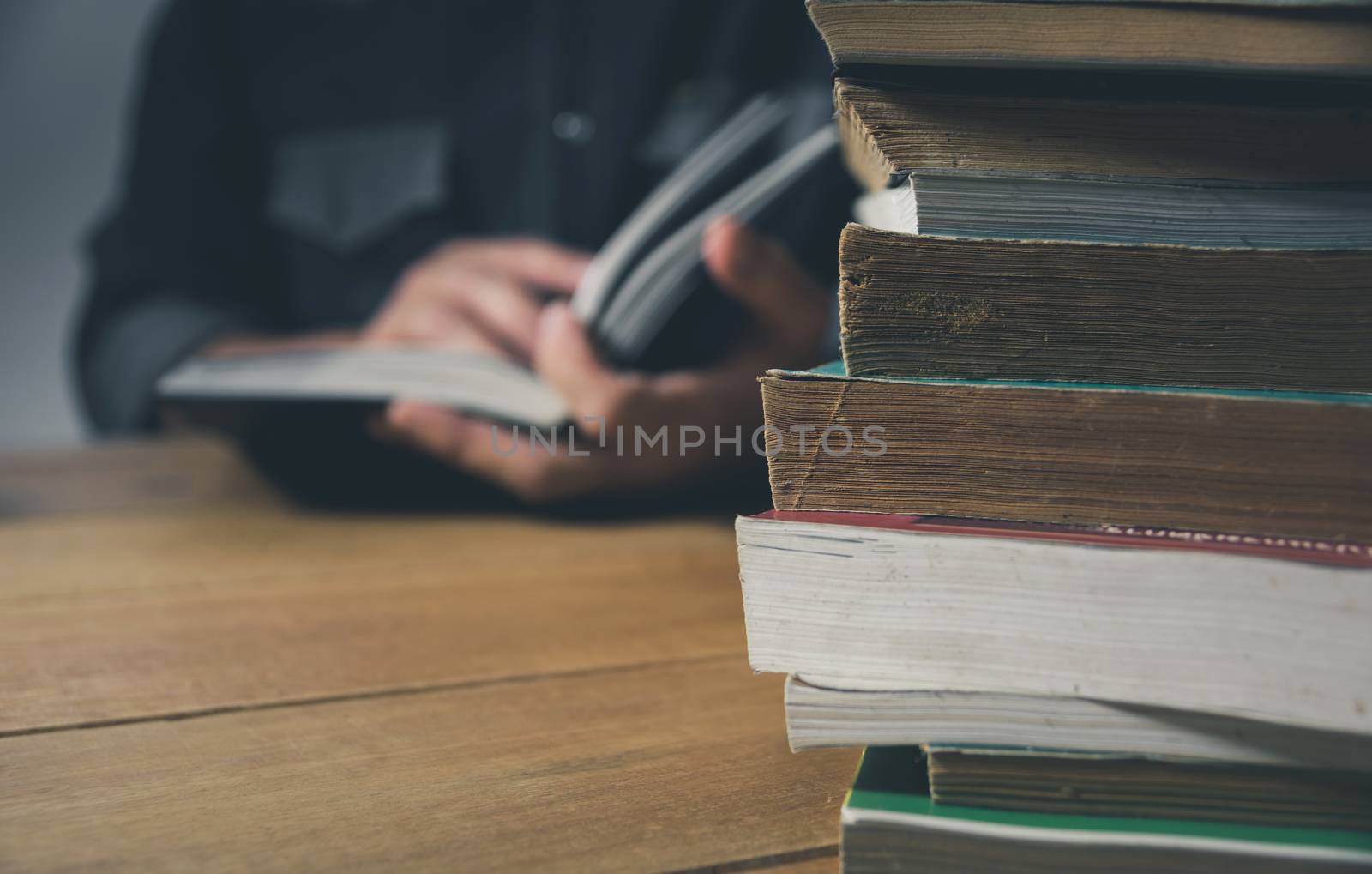 Man reading a book on the table. Education and people concept.