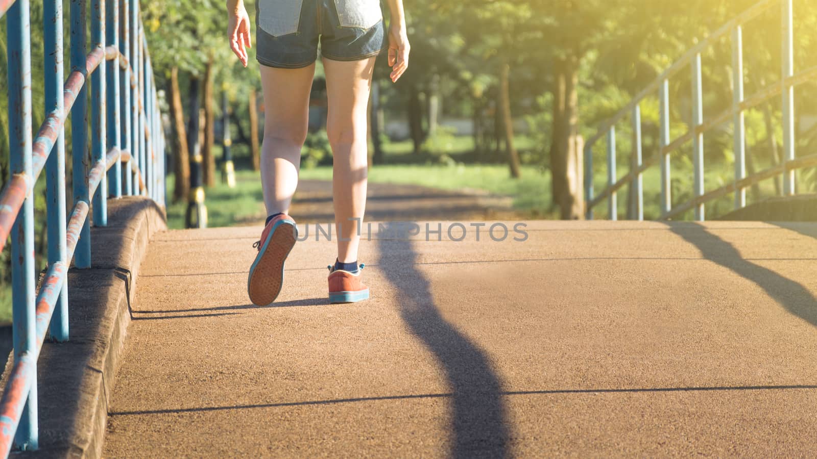 The female walking at the morning for warm up body for jogging and exercise.
