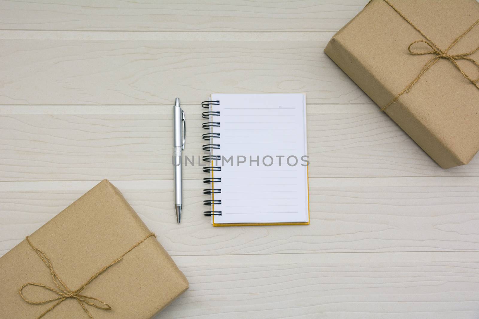 Top view of open book. Book open with pen and boxes on wooden background and copy space for insert text.