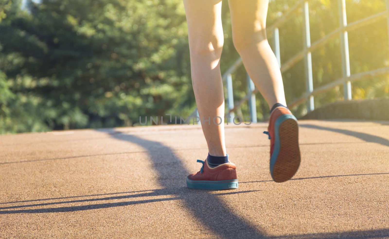 The female walking at the morning for warm up body for jogging and exercise.