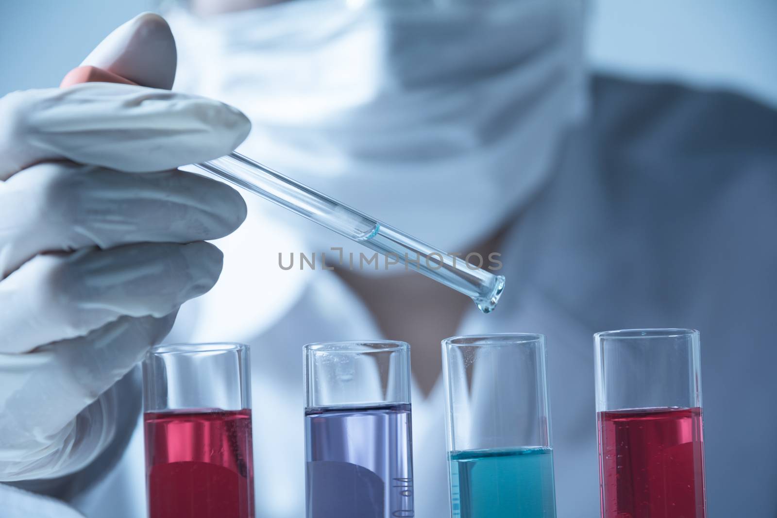 Researcher with glass laboratory chemical test tubes with liquid for analytical , medical, pharmaceutical and scientific research concept.