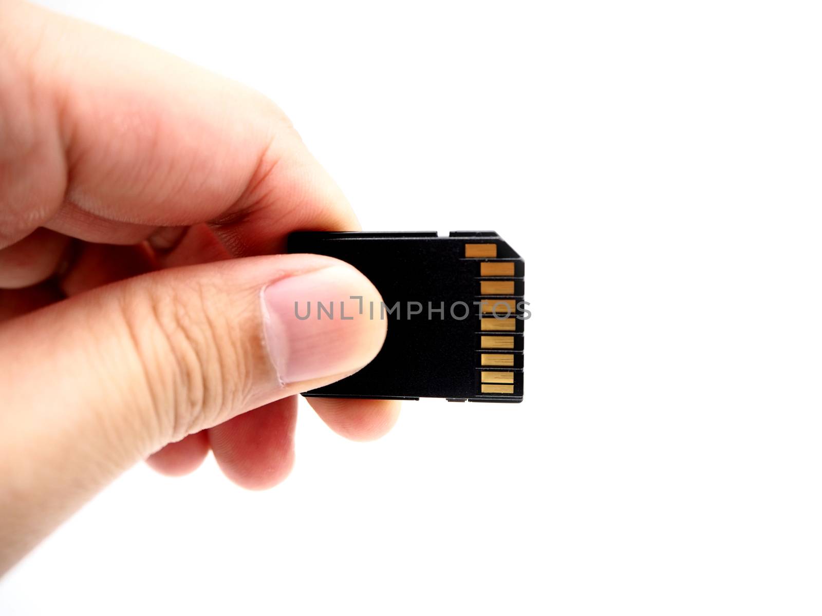 Hand holding a memory card isolated on white background.