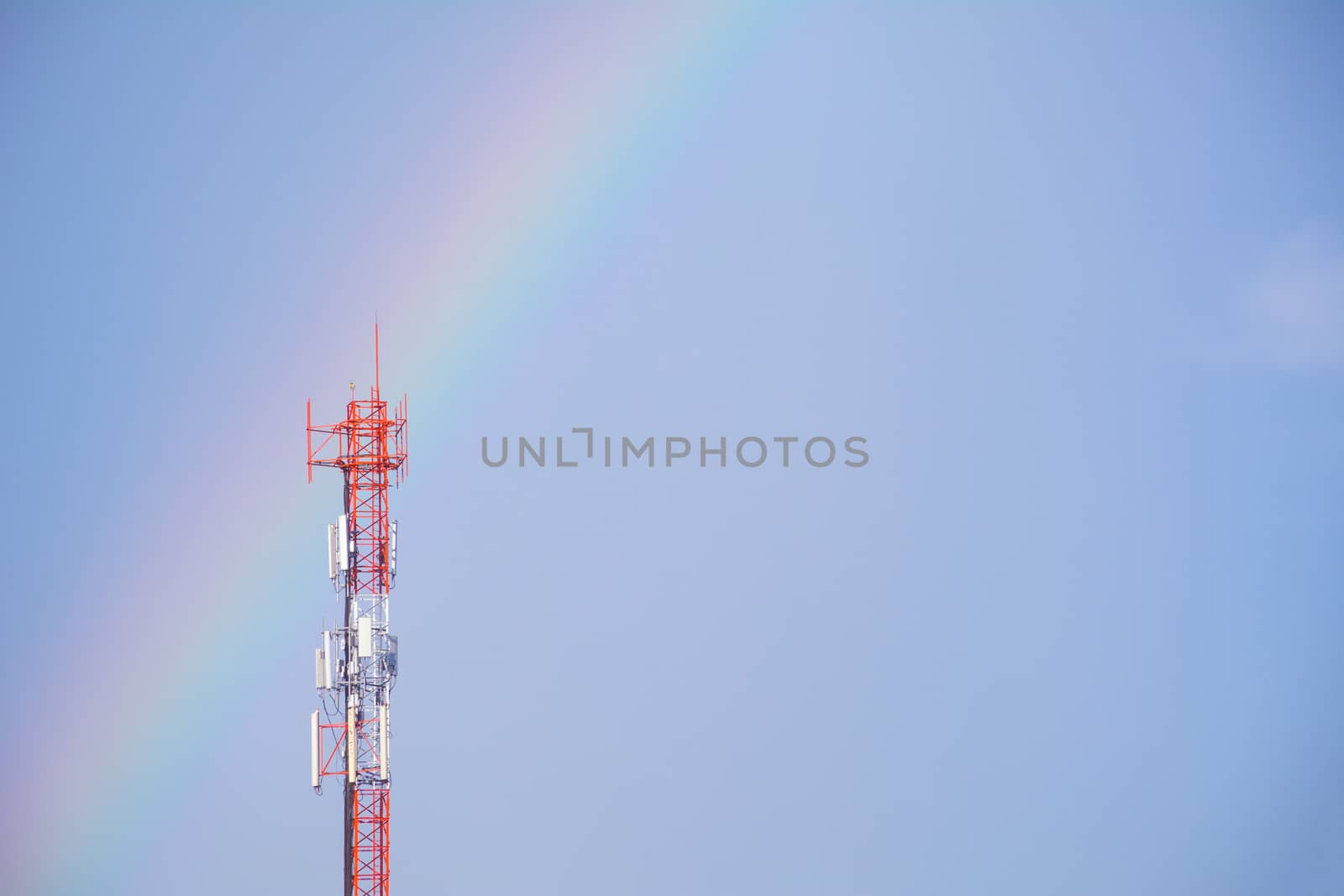 Telecommunication mast TV antennas wireless technology on blue sky background and copy space.