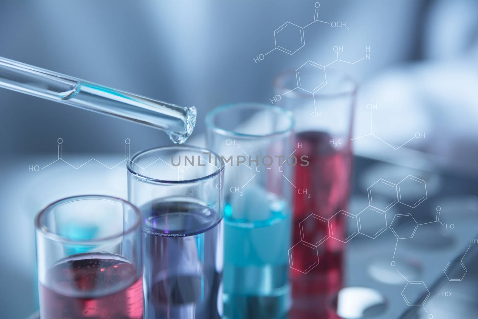 Researcher with glass laboratory chemical test tubes with liquid for analytical , medical, pharmaceutical and scientific research concept.