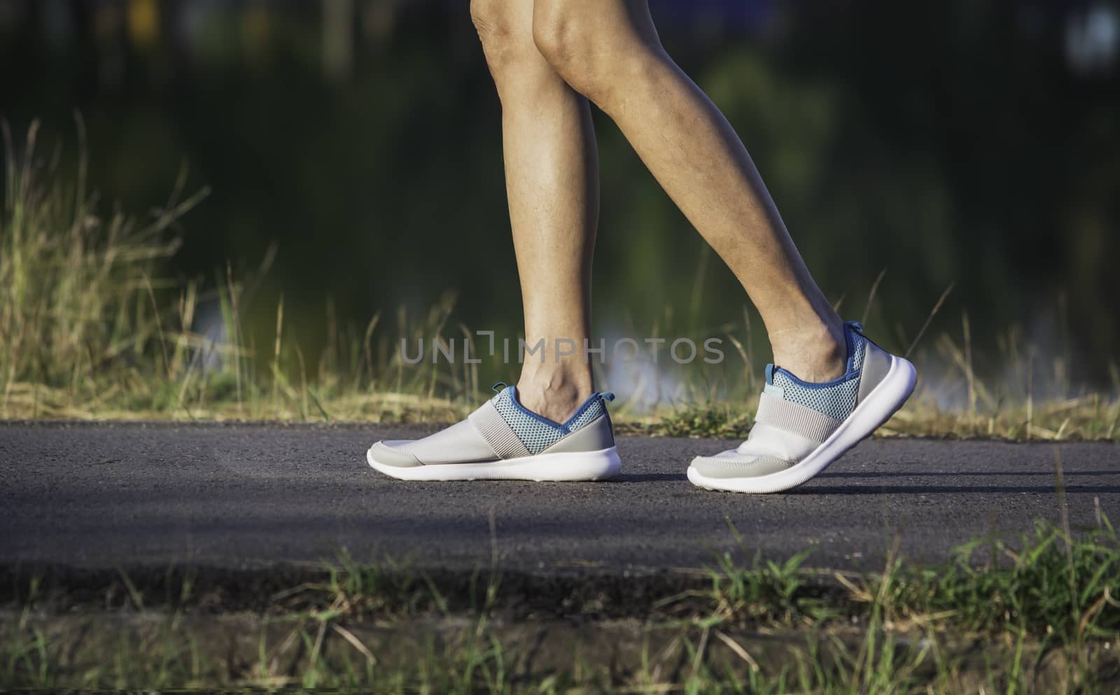 The female walking at the morning for warm up body for jogging and exercise.