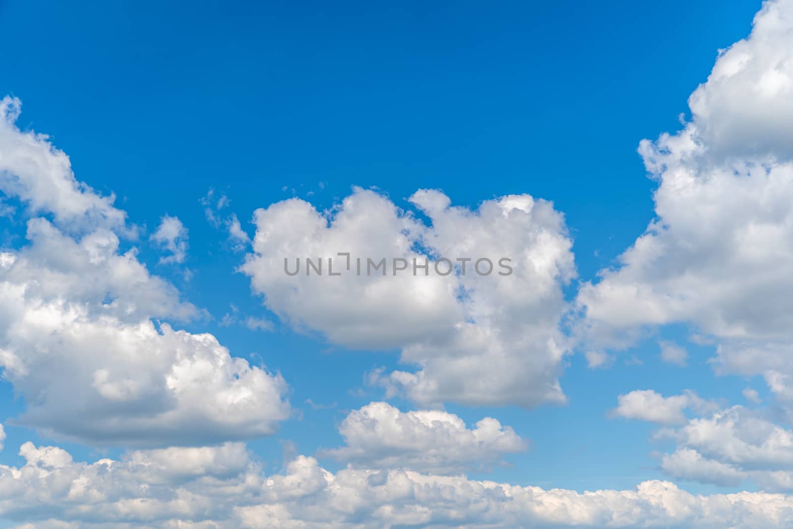 blue sky with white clouds in sunny weather.