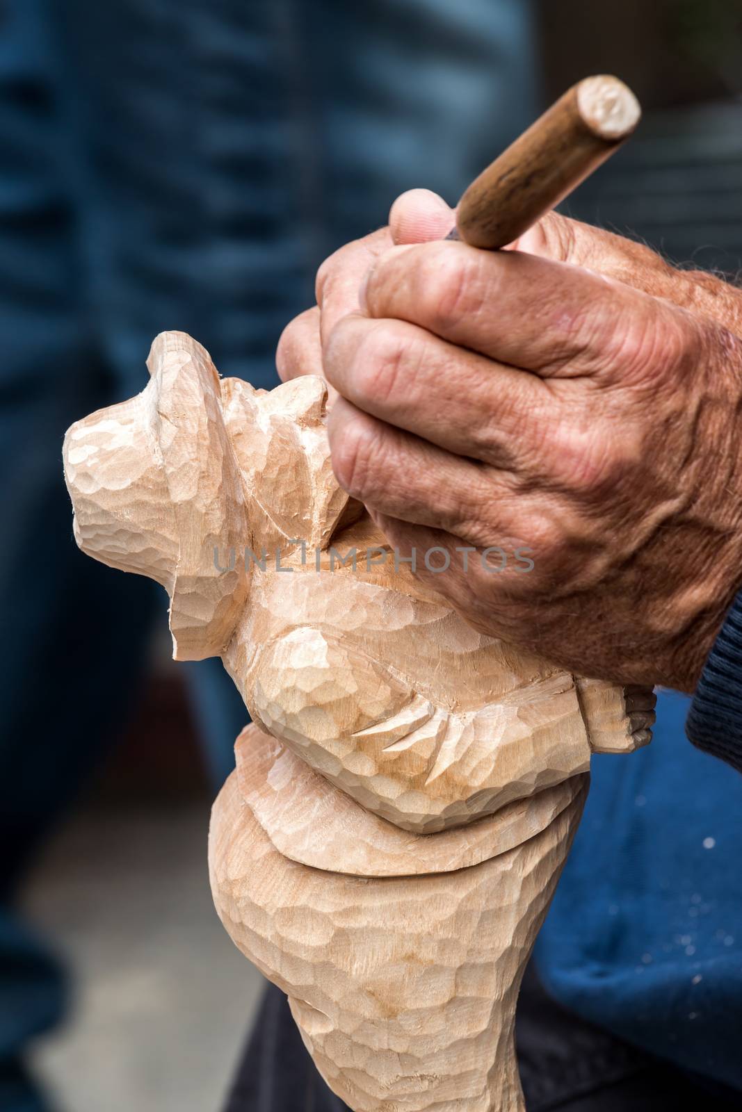Skilful carver working in a small figure