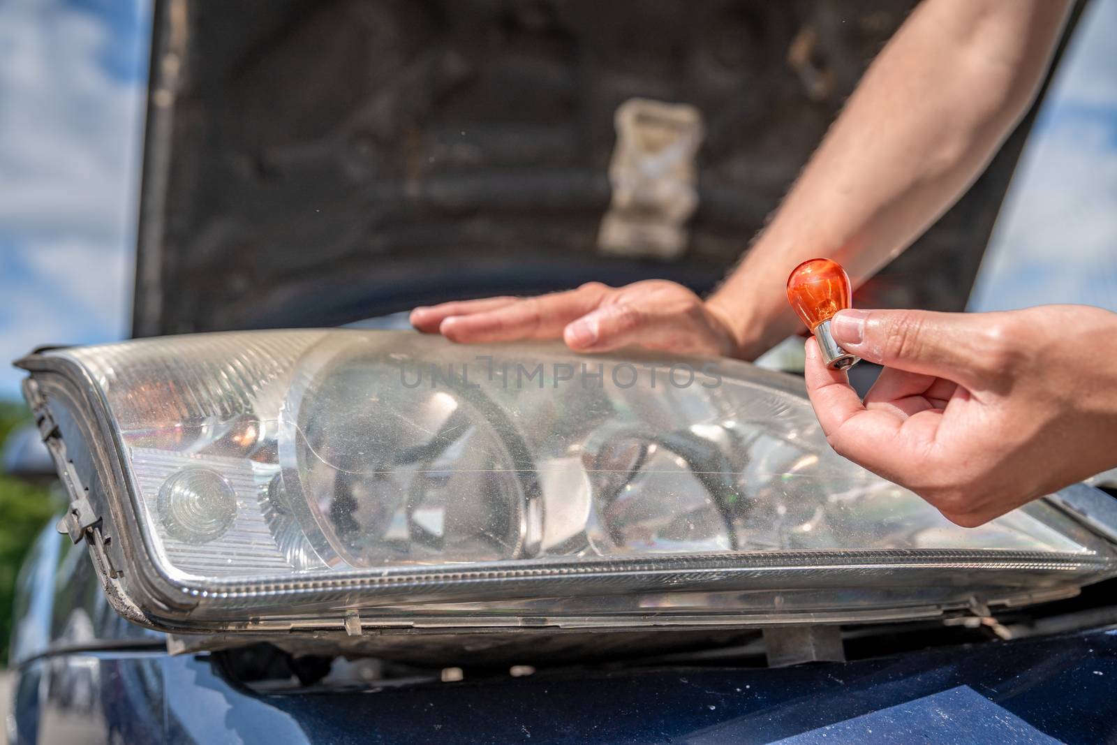 replacement of the bulb in the front headlight of a passenger car by Edophoto