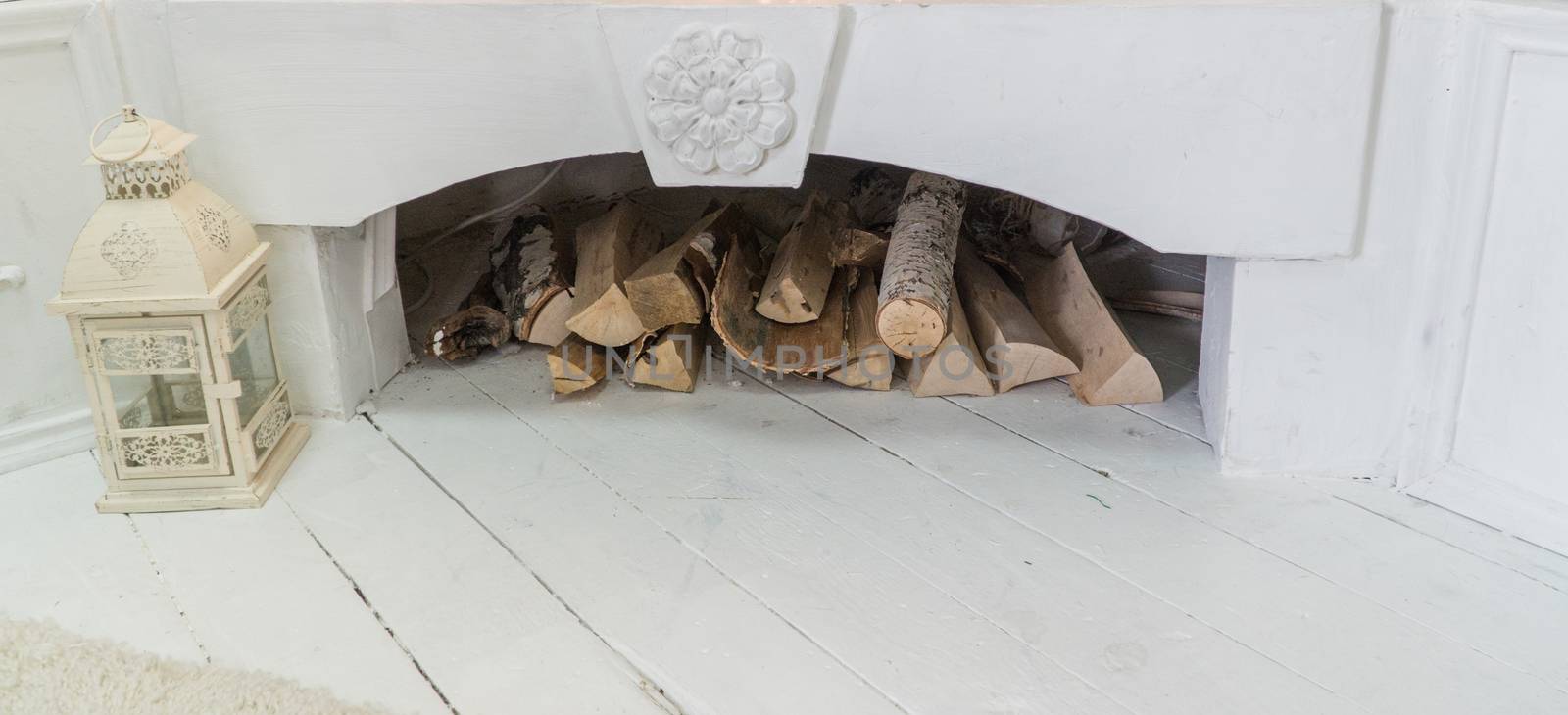 white decorated fireplace with firewood