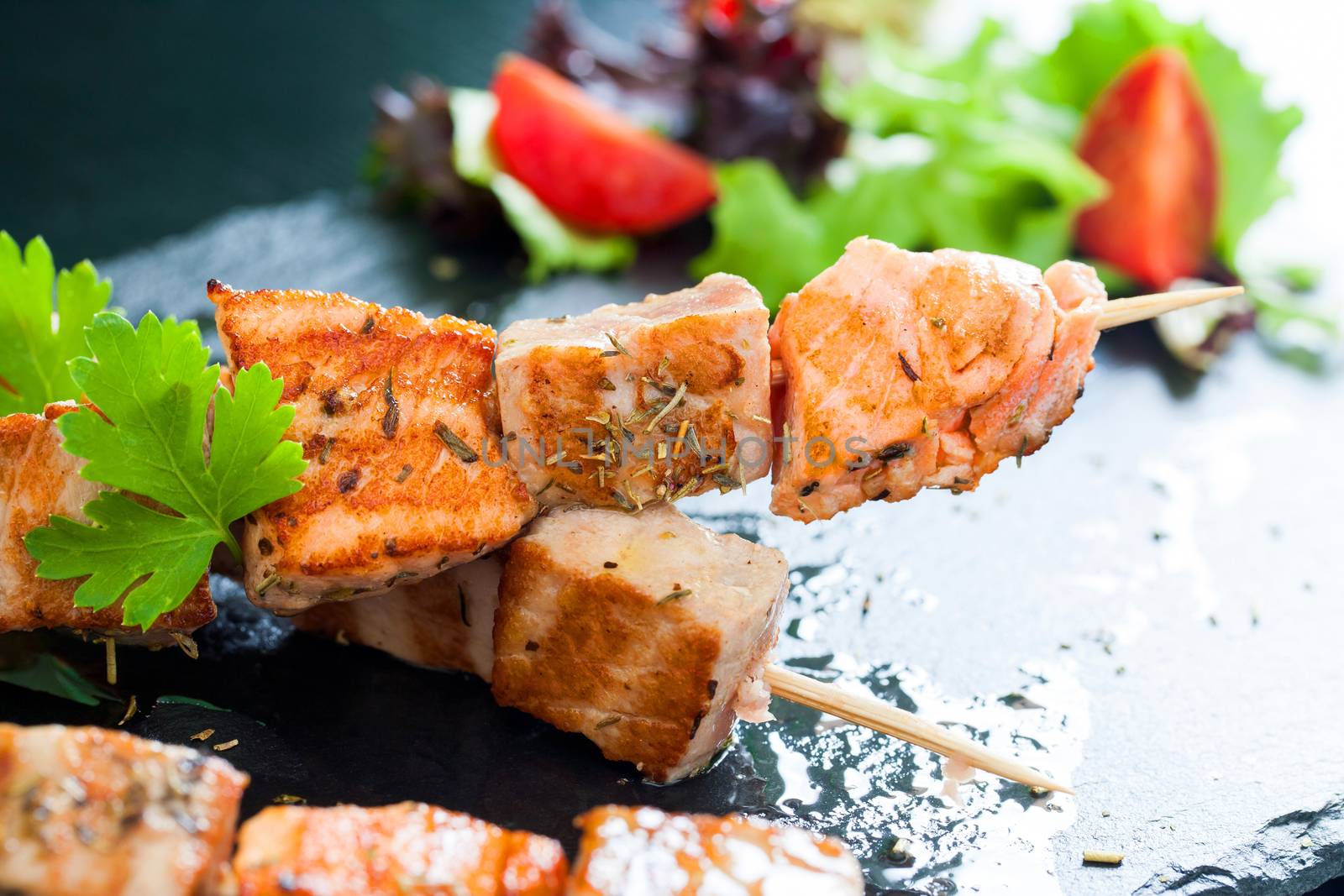 Macro close up of fresh tuna and salmon brochettes grilled.