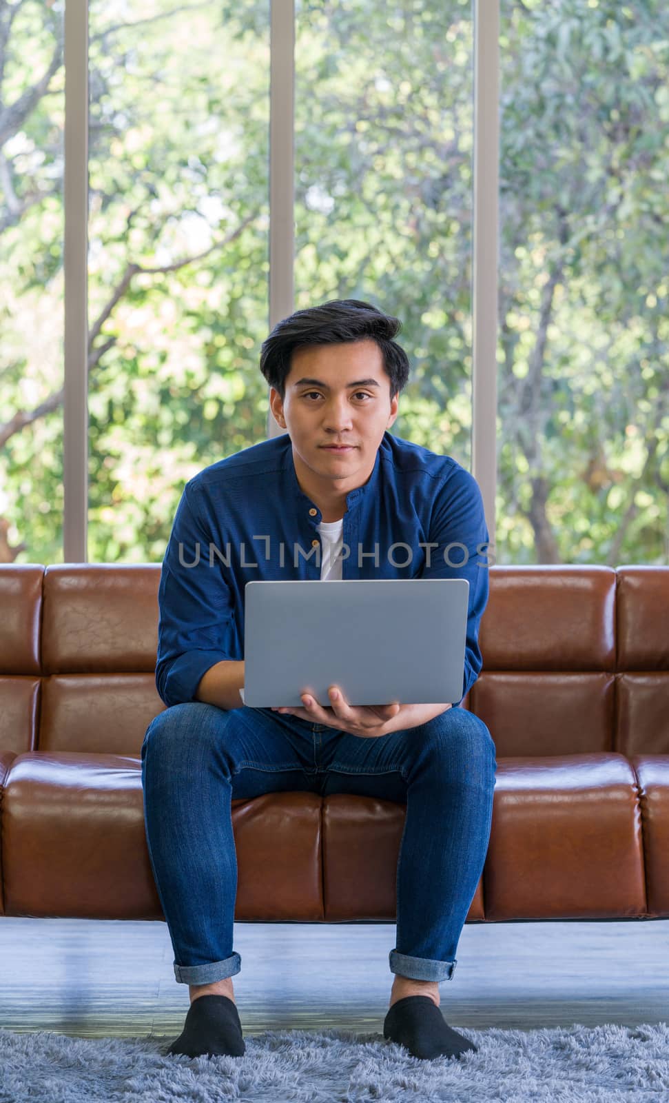 The young man use laptop computer to search for jobs. by chadchai_k