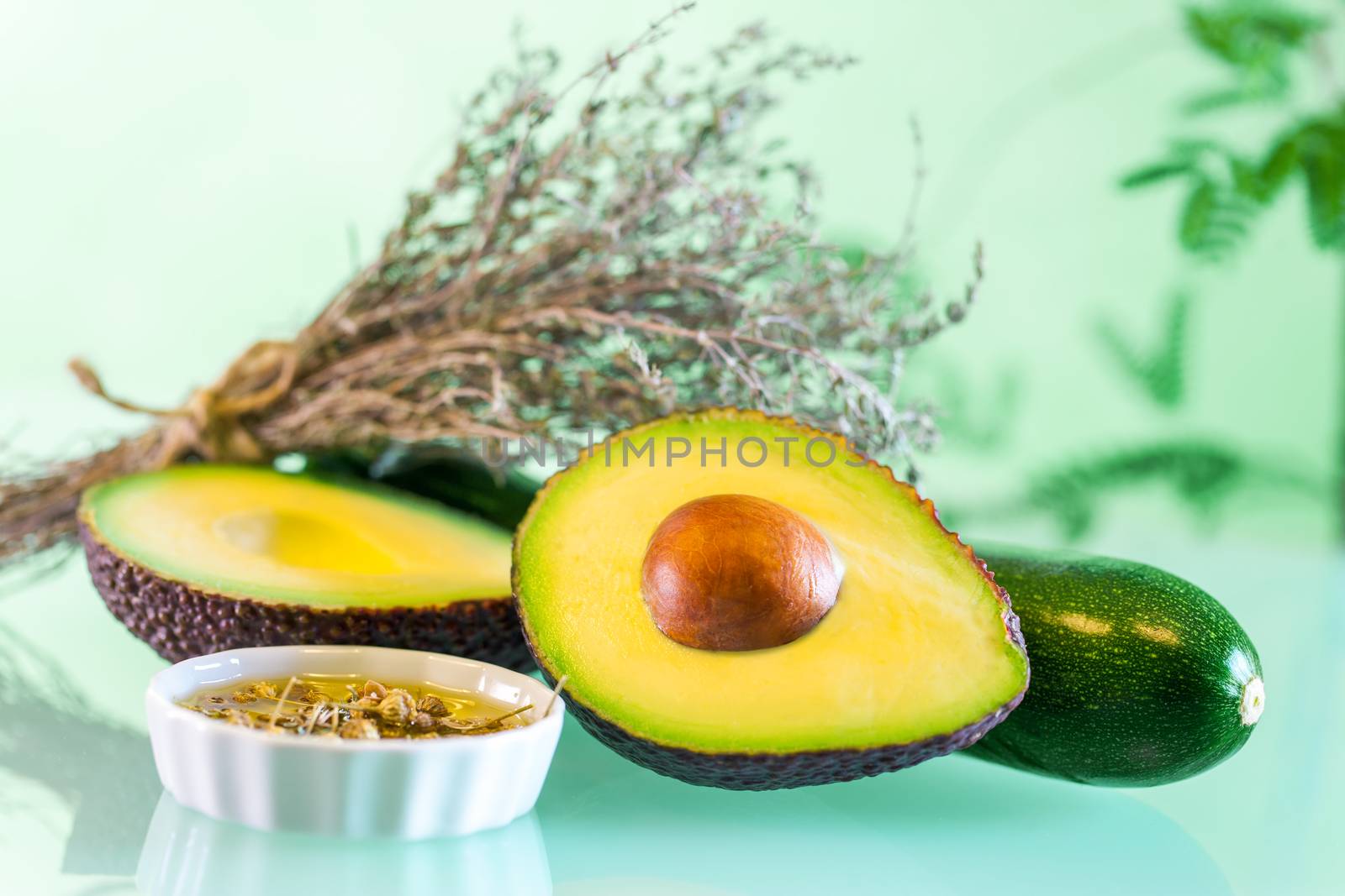 Macro close up Avocado with essential oil and aromatic dried rosemary.