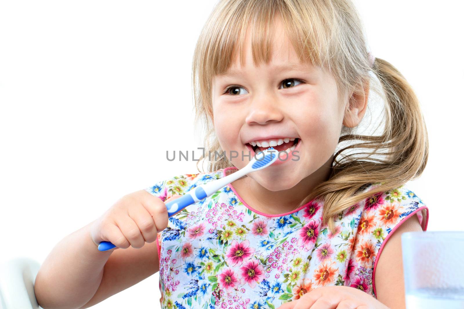 Close up portrait of cute five year old brushing teeth.Isolated on white background.