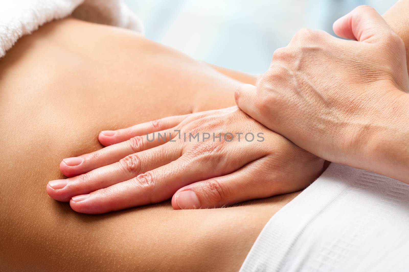 Macro close up of Osteopathic belly massage.