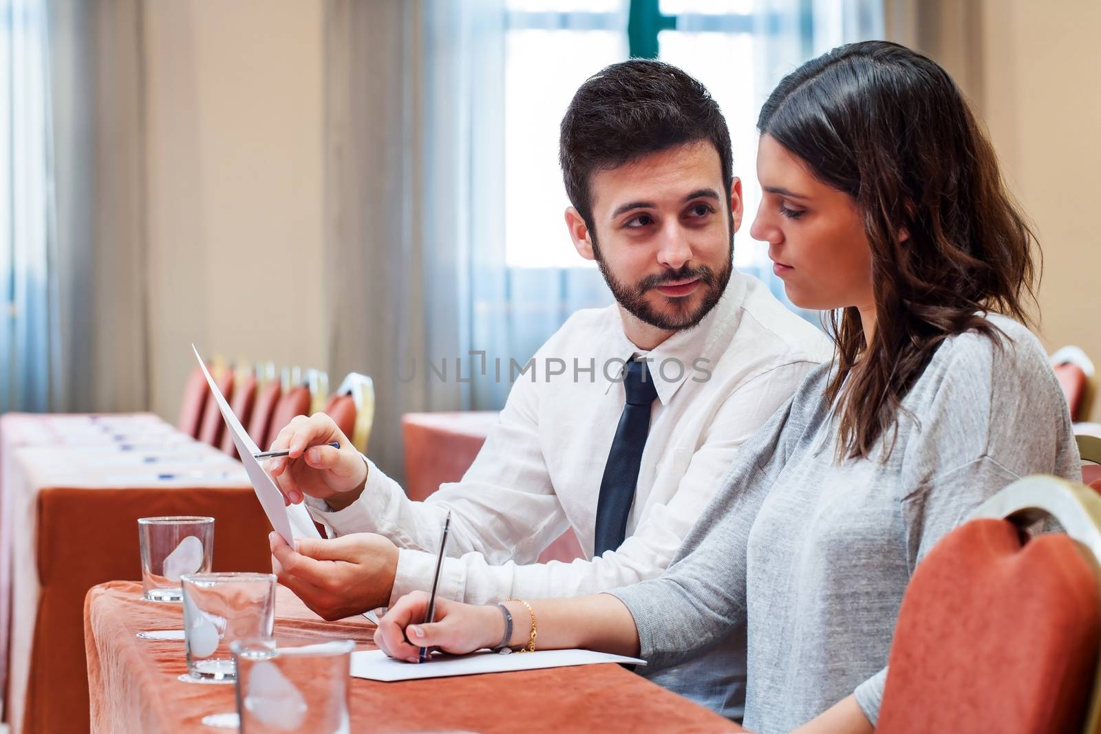 Business couple reviewing work in conference room. by karelnoppe