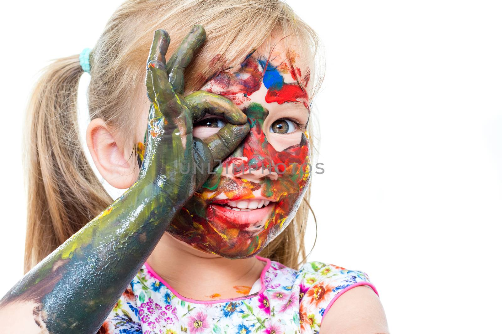 Close up portrait of Little girl messed with color paint. Infant doing okay sign in front of eye.Isolated on white background.