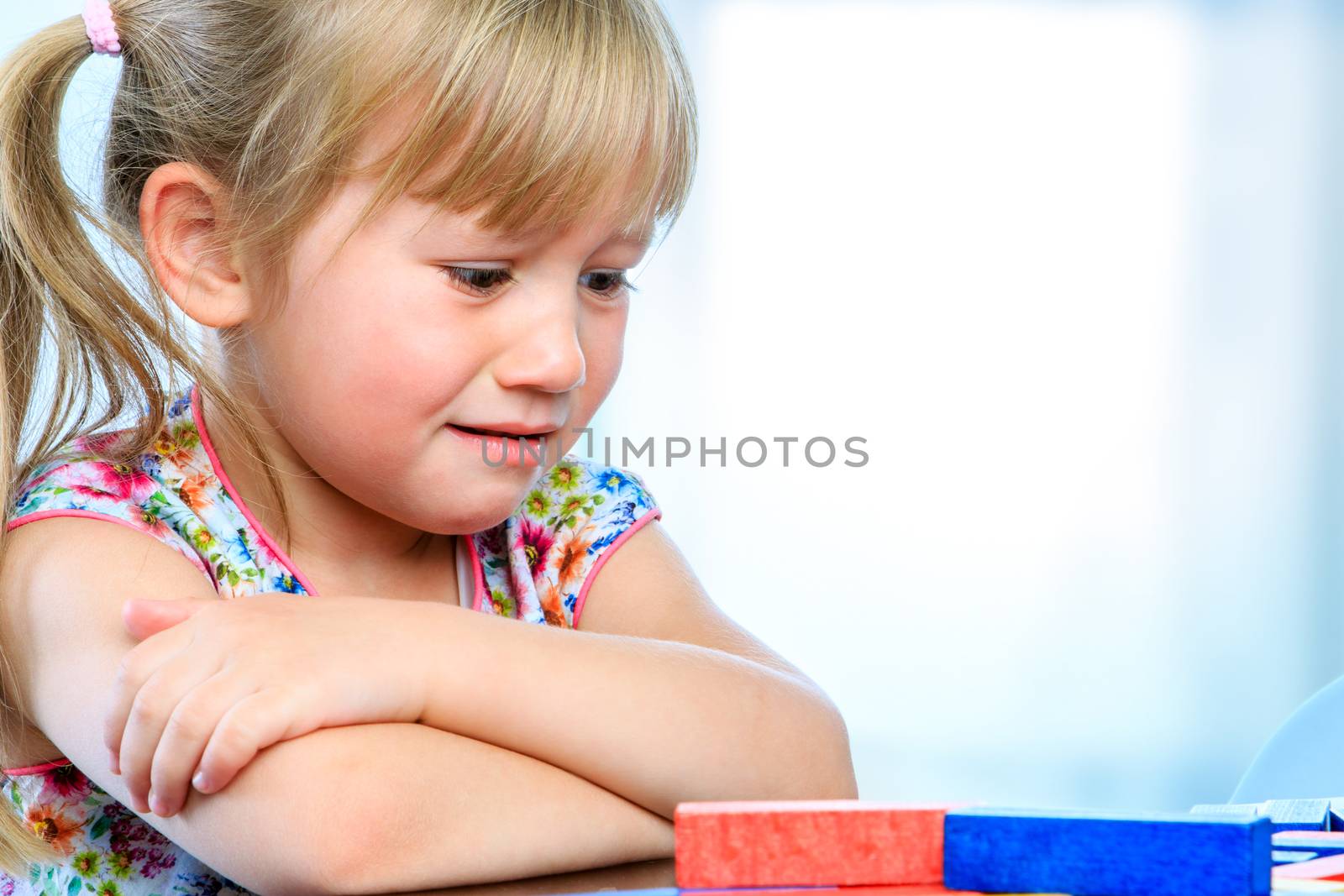 Frustrated youngster at table with game. by karelnoppe