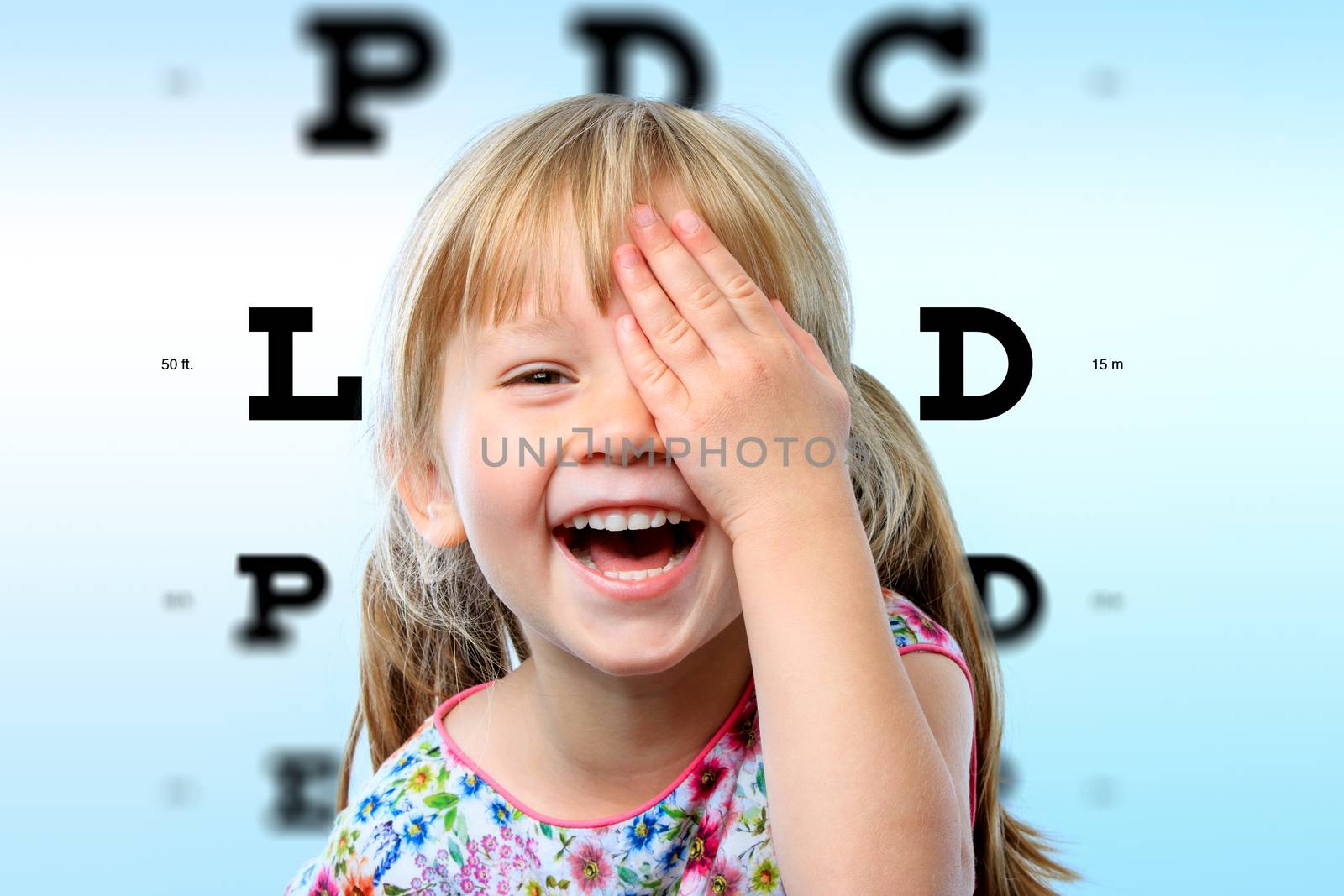 Girl having fun at vision test. by karelnoppe