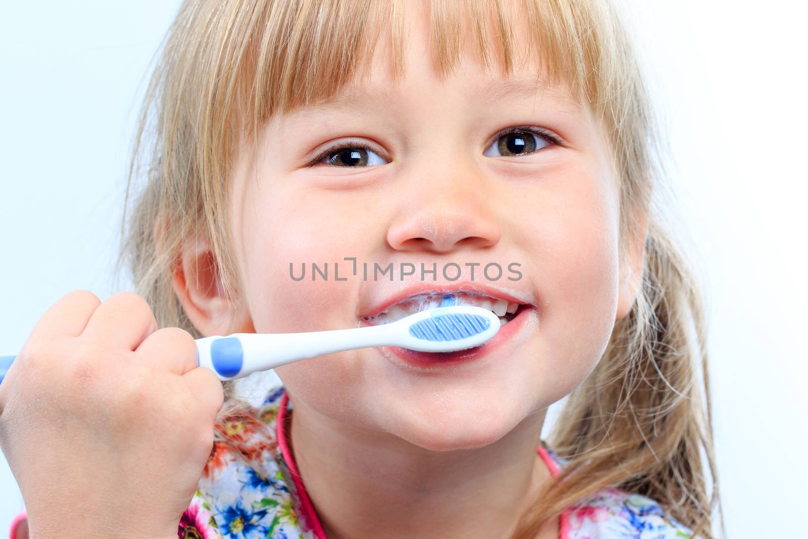 Macro close up Face shot of infant brushing teeth.