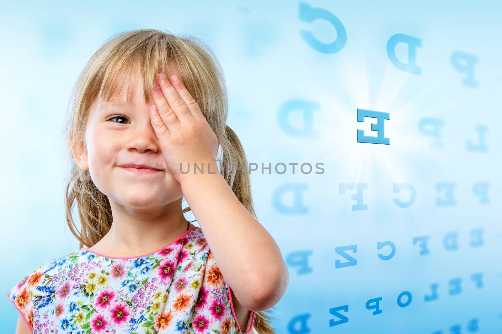 Close up portrait of little girl reading eye chart. Young kid testing one eye on block letter vision chart.