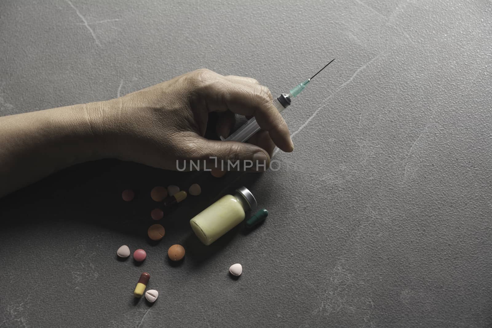 The man committing suicide by overdosing on medication. Close up of overdose pills and addict.