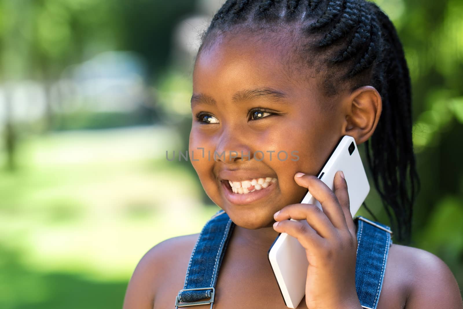 Sweet african girl having conversation on smart phone. by karelnoppe