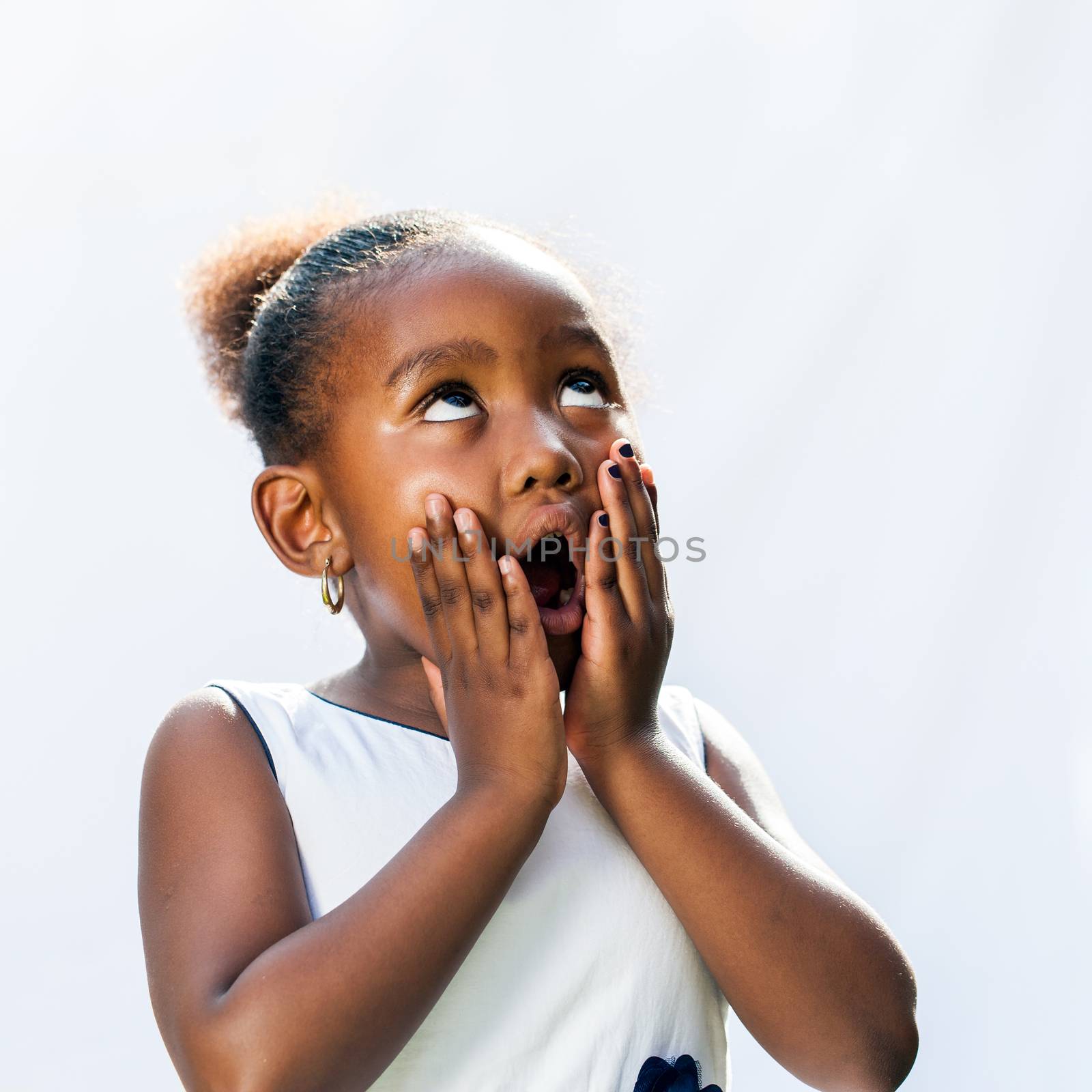 Surprised african girl with hands on face. by karelnoppe