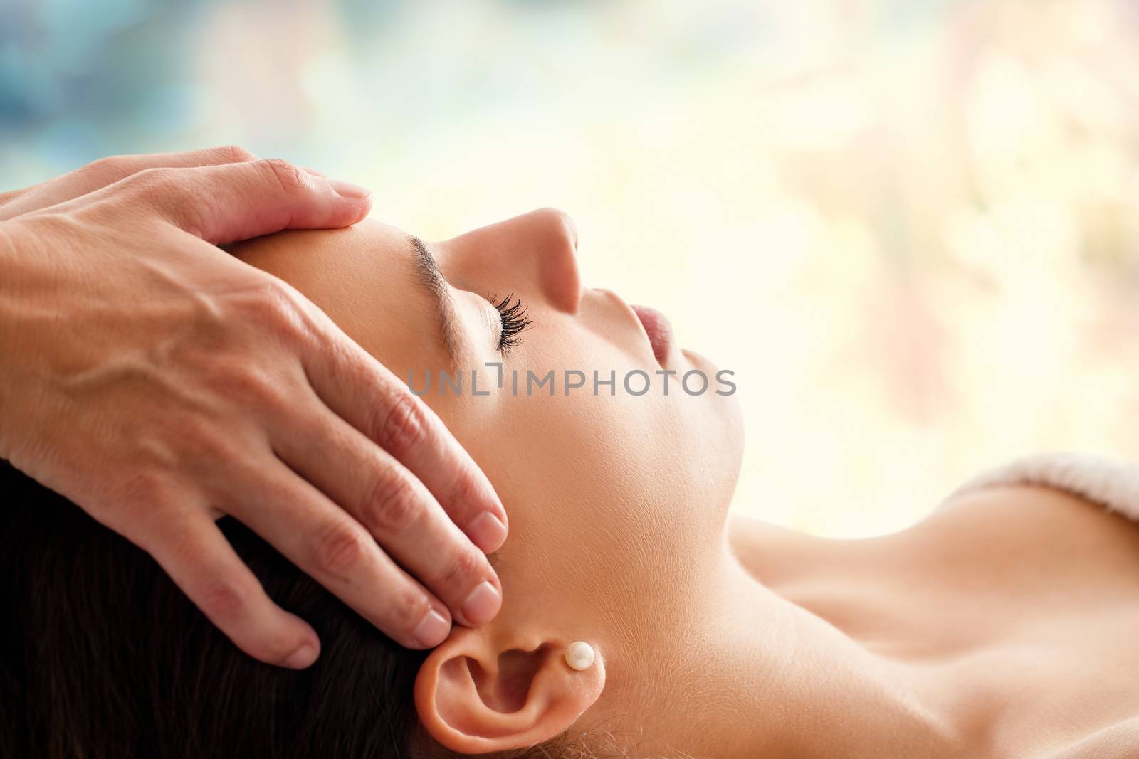 Woman having facial massage. by karelnoppe