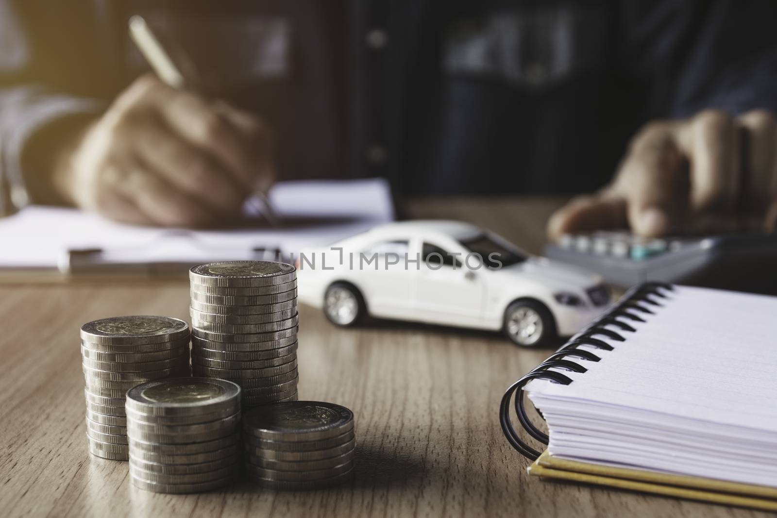 Car insurance and car service. Businessman and toy car for accounting and financial concept.
