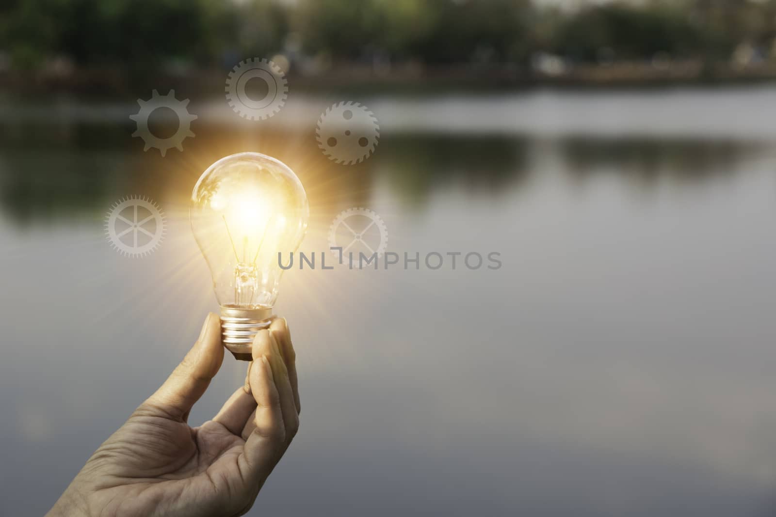 Hand holding a light bulb. Innovation and creative concept.
