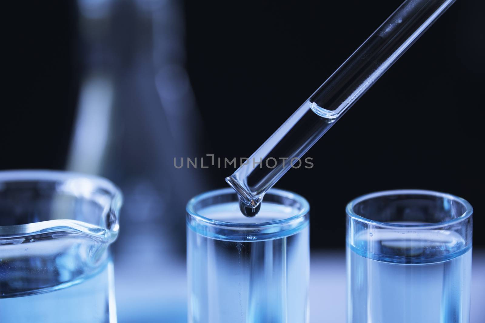 Researcher with glass laboratory chemical test tubes with liquid for analytical , medical, pharmaceutical and scientific research concept.