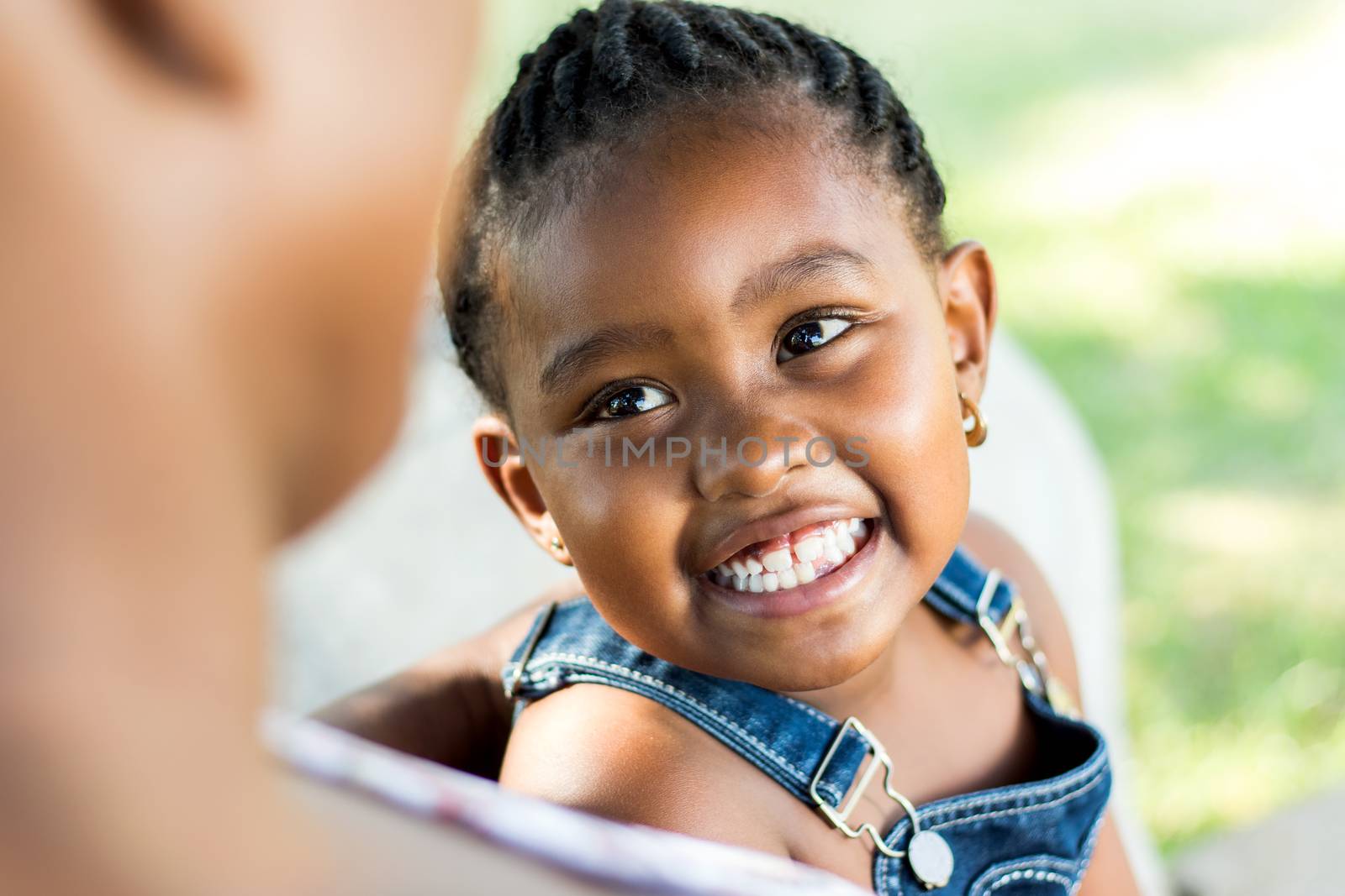 Face shot of african girl laughing. by karelnoppe