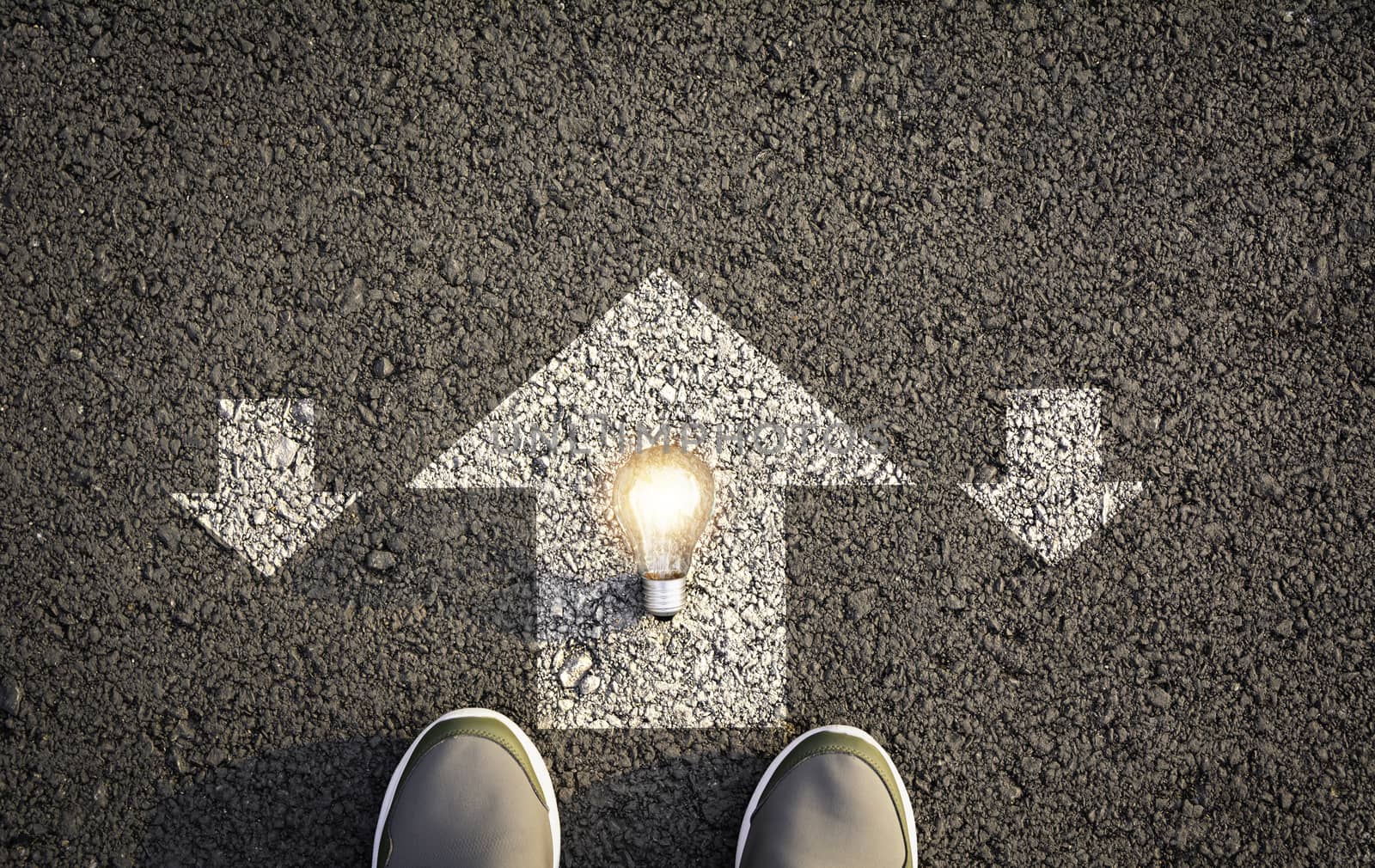 Top view of man wearing white shoes choosing a way marked with white arrows and light bulb. Chooses the right path concept.